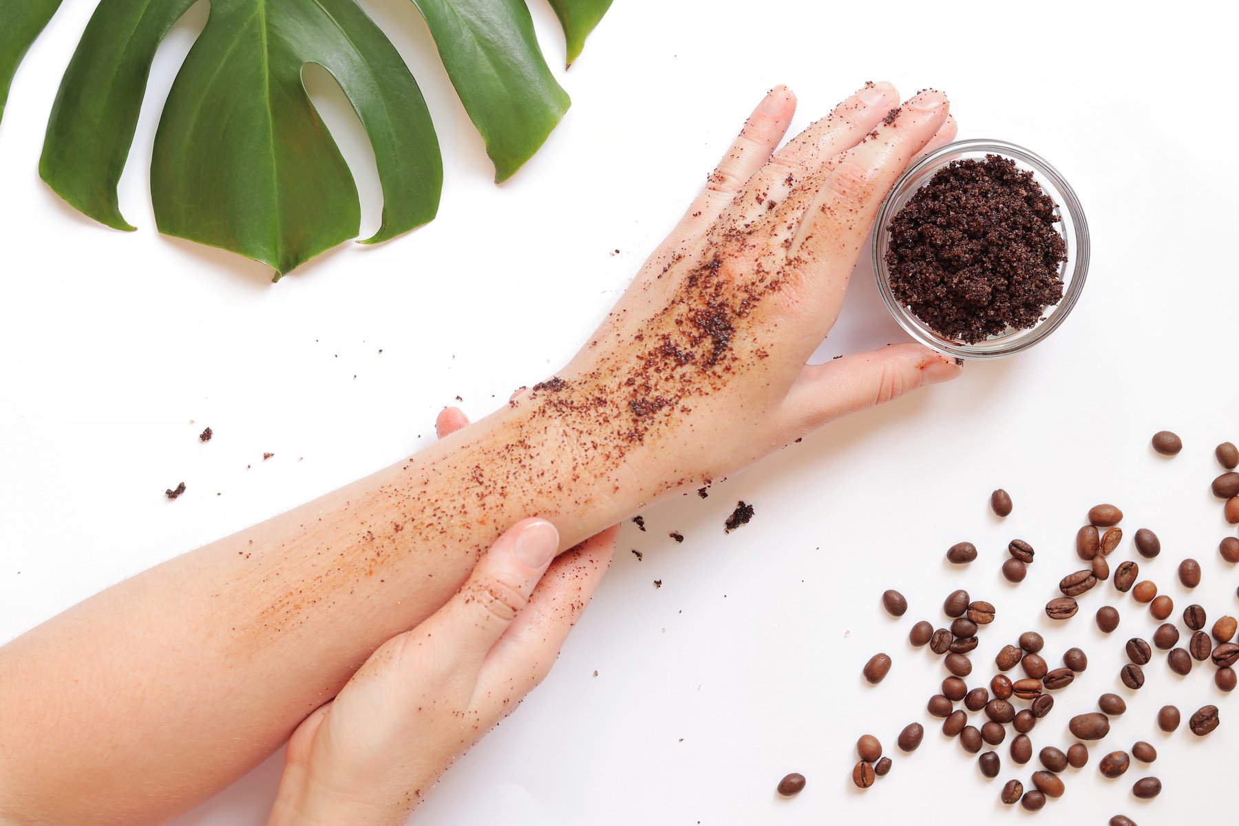 Female hands apply coffee scrub to the skin. The concept of natural cosmetics